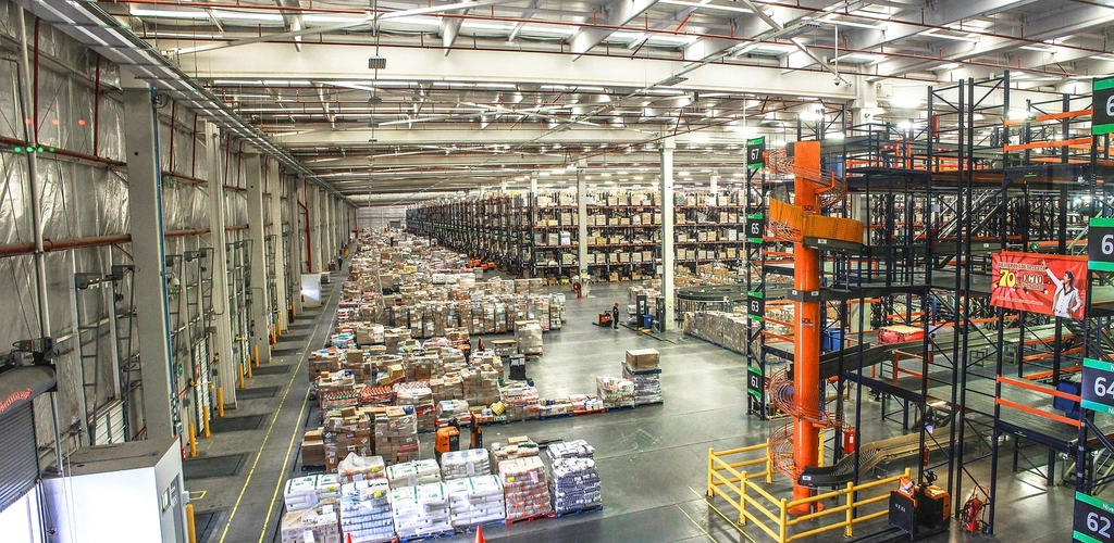 Interior of a large warehouse filled with stacked inventory boxes, illustrating a new product launch with no sales history yet