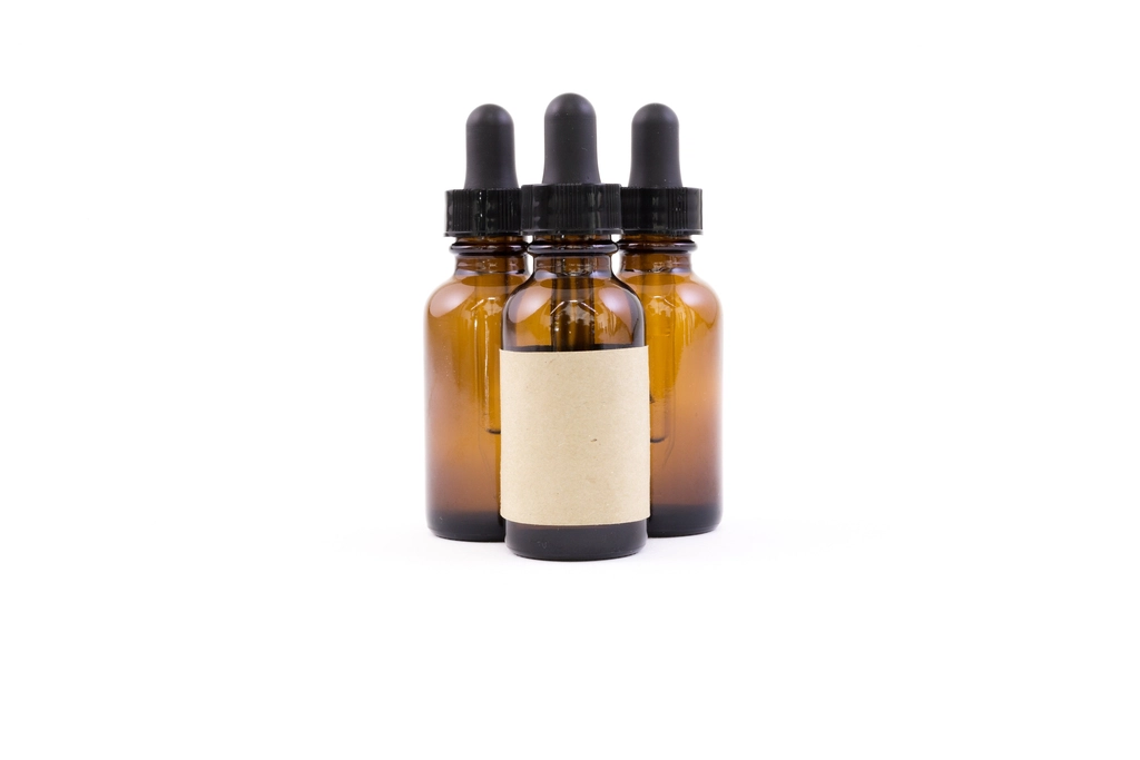 Three amber glass dropper bottles with a blank label, illustrating skincare products that should not be trusted to AI-only images yet